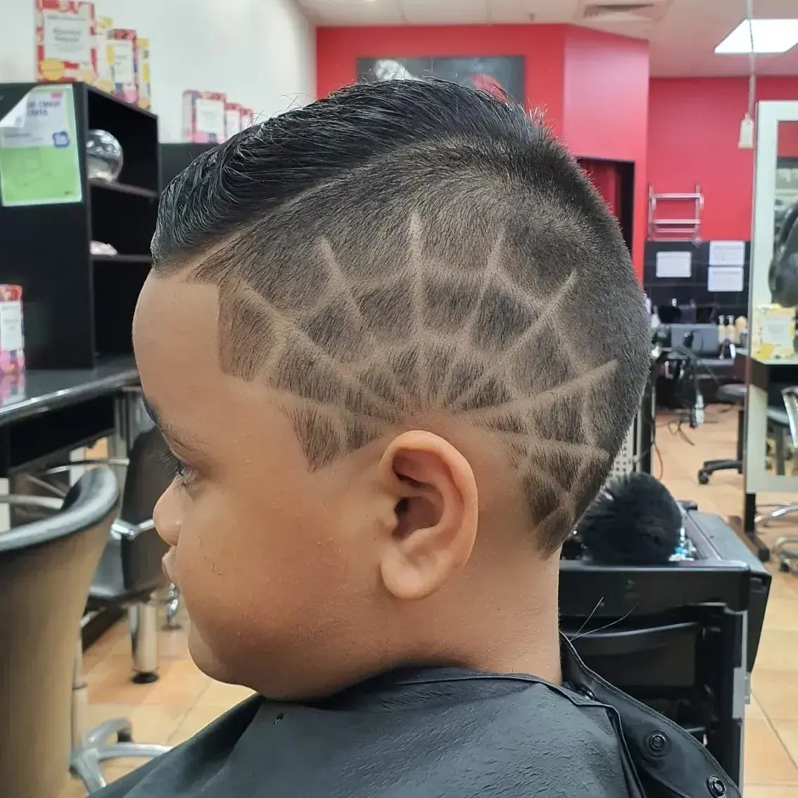 Child having a haircut in our Darwin salon